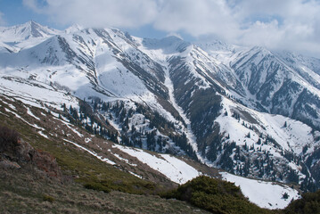 Fototapeta na wymiar Snowy mountain ranges in Alatau near Almaty, Kazakhstan
