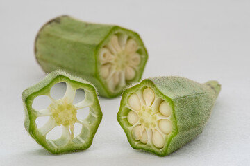 Small pile of green okra on a white background