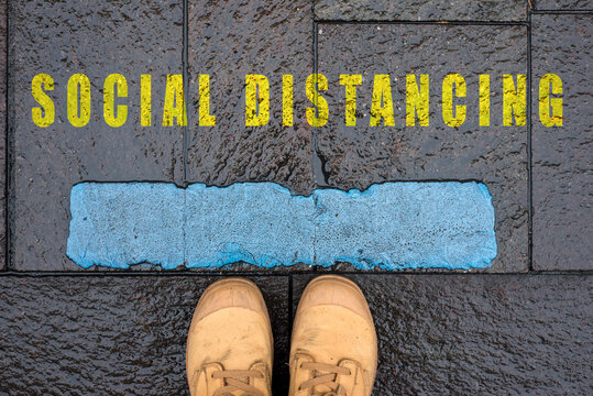 concept message in the road with feet - social distancing