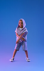 Cute dancing African-American boy on color background