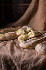 Homemade bread several pieces on a brown background. Home cooking concept. Bakery. Fresh, aromatic, hot bread