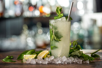 Luxury cocktail and cocktail shaker on black stone background