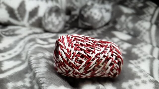 Ribbons for wrapping gifts for Christmas and New Year. Gift wrapping for Christmas. Red, white and silver ribbons in spools fall onto the soft blanket. Festive background.