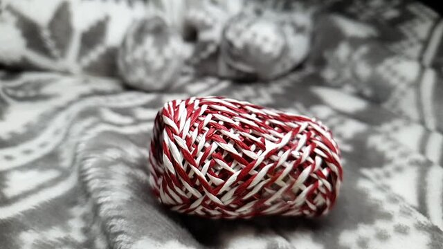 Ribbons for wrapping gifts for Christmas and New Year. Gift wrapping for Christmas. Red, white and silver ribbons in spools fall onto the soft blanket. Festive background.