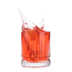 Glass of classic negroni cocktail with splashes on white background