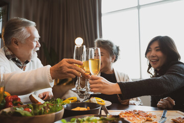 Asian family having dinner at dining table at home