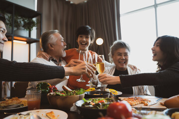 Asian family having dinner at dining table at home