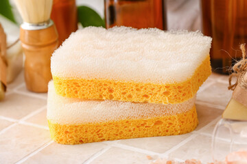 Obraz na płótnie Canvas Bath sponges on tile table, closeup