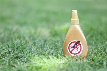 Mosquito repellent on green grass outdoors