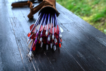Arrows in a quiver for archery training on a wooden table