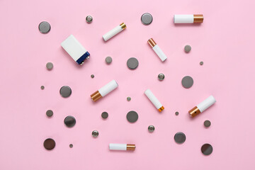 Different batteries on pink background
