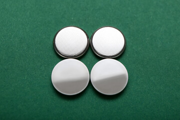 Lithium button cell batteries on green background
