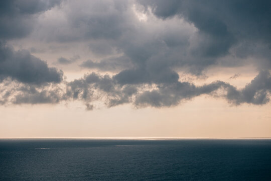 Aerial View Of A Single Big Cargo Ship On The Sea Over Cloudy Blue Sky