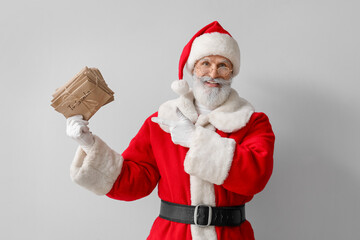 Santa Claus with letters on grey background