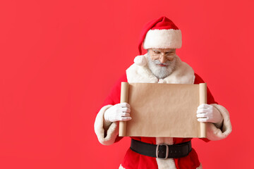 Santa Claus with blank letter on color background