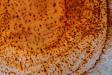 Rusty orange spots on the gray surface. Top view