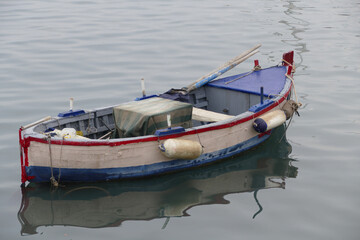 Fototapeta na wymiar La vecchia barca del pescatore attraccata al molo