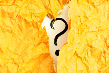 a question mark and yellow crumpled paper . FAQ frequency asked questions, Answer and Brainstorming...
