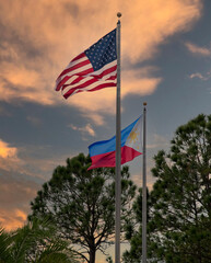 American and  Filipino flags against sky