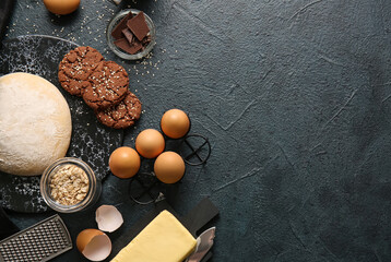Fototapeta na wymiar Board with fresh dough for preparing homemade cookies on black background