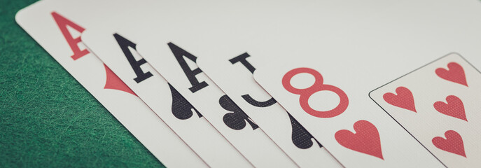 Playing cards and board game figures arranged on a poker table in a casino. Poker card game, winning combination.