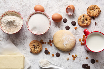Fresh dough and ingredients for preparing homemade cookies on light background