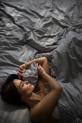 Pretty, young woman in her bed, fast asleep. Importance of sleep concept