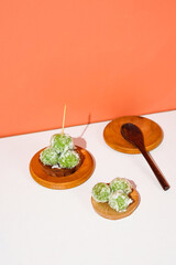 klepon, one of the Indonesian traditional foods. the rice ball cake in green filled with brown sugar. a local food shot for presentations or promotions.