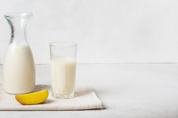 Alternative, vegetable, vegetarian potato not milk. Vegetable, non-allergenic white drink poured into a glass bottle and glass, Fresh potatoes cut into slices nearby, copy space.