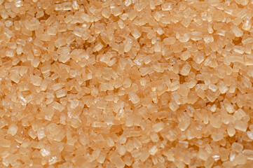 kryształki brązowego cukru trzcinowego jako tło w dużym zbliżeniu © Henryk Niestrój