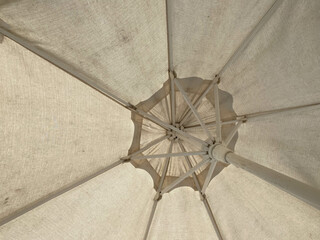 Sun parasol under coconut trees against blue sky on a very hot day