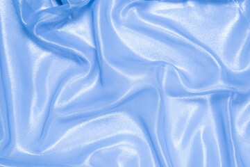 Blue shiny pearl fabric as a background.
