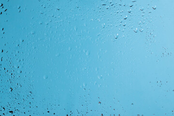 Blue backgrond with water drops. Wet glass.
