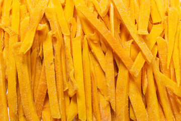 Dry tasty mango slices as a background.