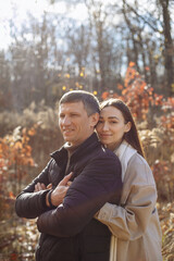 Fototapeta premium couple in love in the park on the background of autumn trees