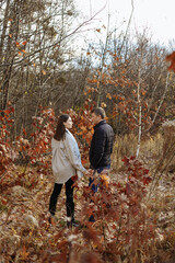 Fototapeta premium couple in love in the park on the background of autumn trees