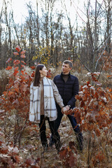 Fototapeta premium couple in love in the park on the background of autumn trees