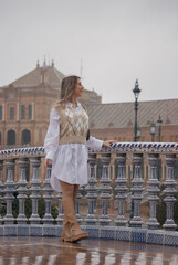 Young girl walking smiling in Plaza of Spain in Seville enjoying the view. Travel during corona virus Concept.