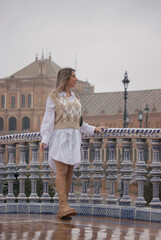 Young girl walking smiling in Plaza of Spain in Seville enjoying the view. Travel during corona virus Concept.