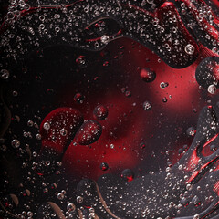 Abstract space surreal black and red background, oil bubbles in water