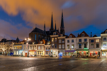 Delft Town Square at Sunset. A picturesque view of the historic town square of Delft bathed in the warm glow of sunset.