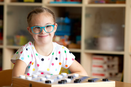 Girl with Down Syndrome playing checkers