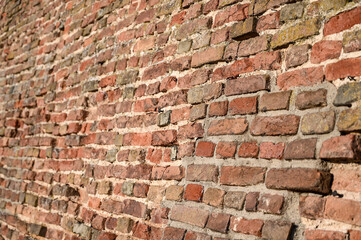 Colorful brick wall on the house. Texture of red stone blocks, close up. Background.