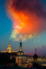 Fototapeta na wymiar Fireworks over St. Andrew's Monastery in front of Moscow State University from the observation deck of the Russian Academy of Sciences