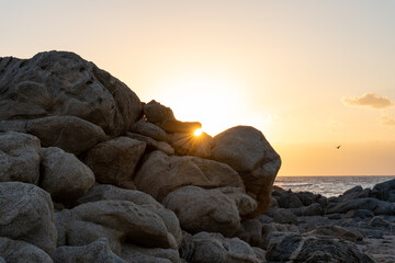 Sunlight graces the boulders of Dhofar, casting shadows and highlighting the intricate textures of...