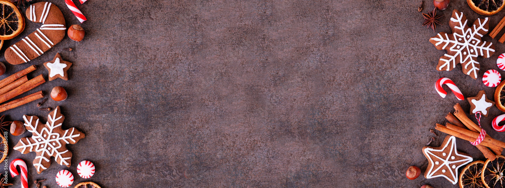 Poster christmas baking double border with cookies, peppermints and spices. overhead view on a dark stone b