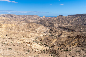 Fototapeta na wymiar Desert Panorama. Expansive view of Oman's rocky and rolling landscape of gorges and canyons.