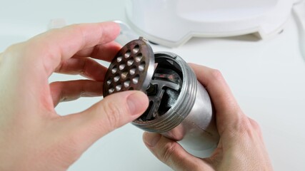 Woman hands assembling modern electric meat grinder, mincer for making minced meat