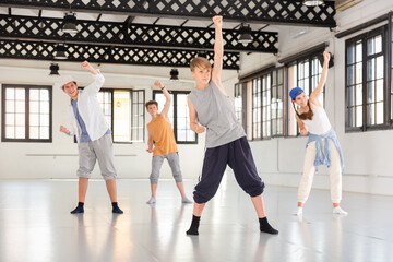 Fototapeta premium Emotional teenage dancers having hip-hop dance training at dance hall