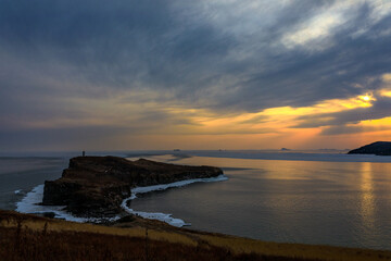 Picturesque rocky coast of the Russky Island in Vladivostok. Rocky coast of the Sea of Japan during a bright sunset.